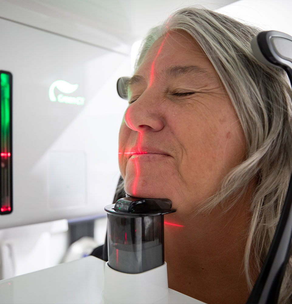 patient in the middle of taking a dental x-ray