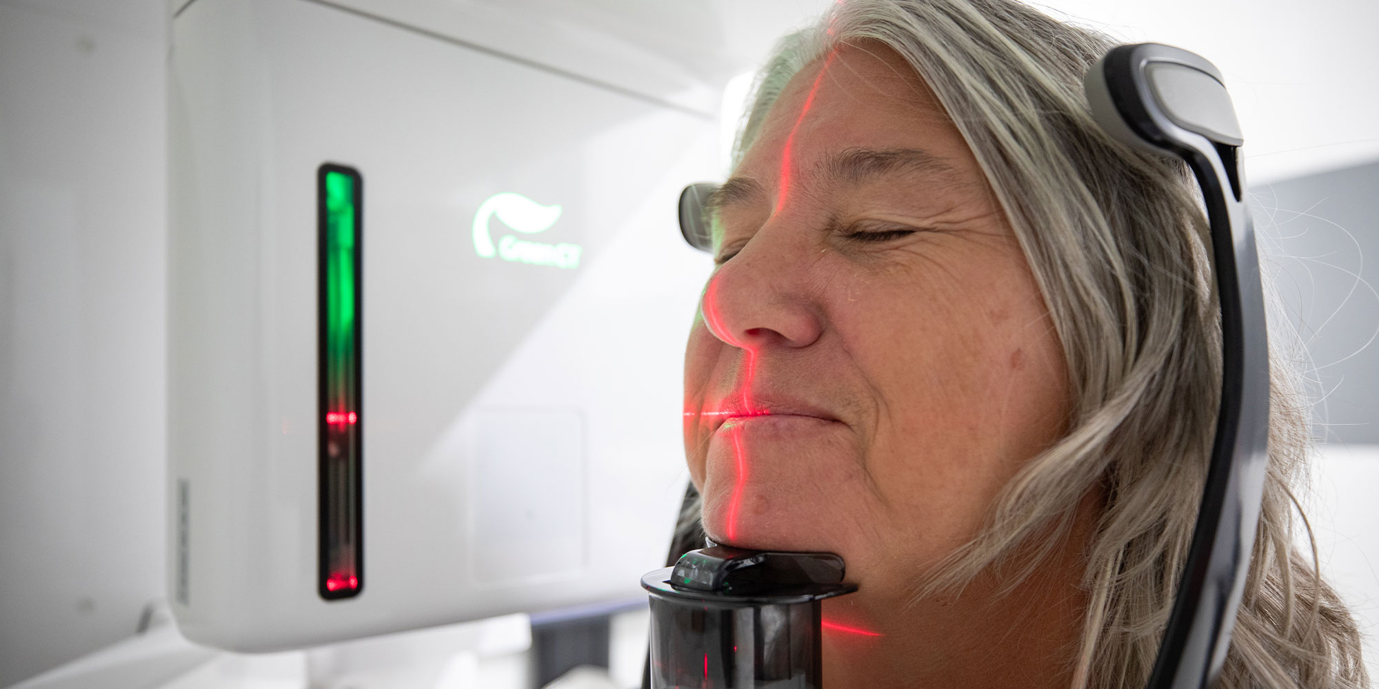patient in the middle of taking a dental x-ray