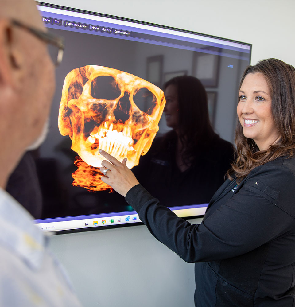 team member going over x-ray with patient
